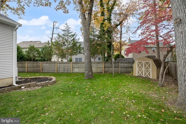 a aerial view of a house with a yard and large trees