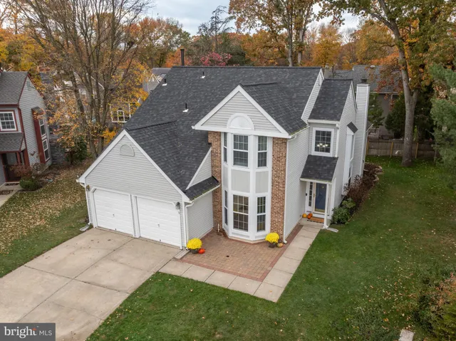an aerial view of residential houses with outdoor space and street view