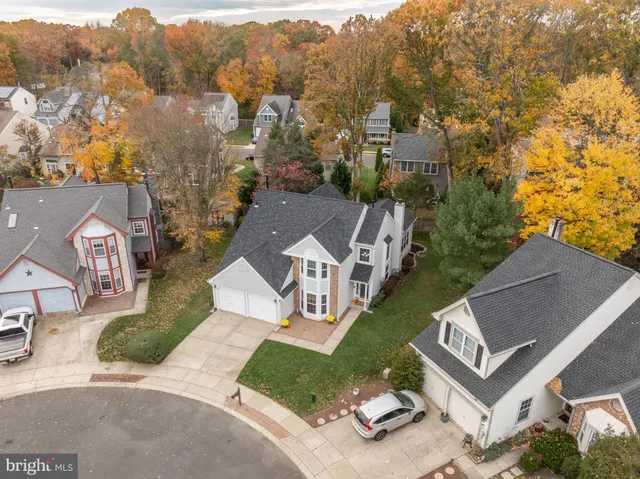 an aerial view of multiple houses with yard