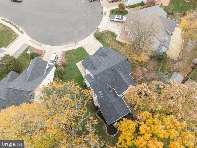 an aerial view of a house with yard