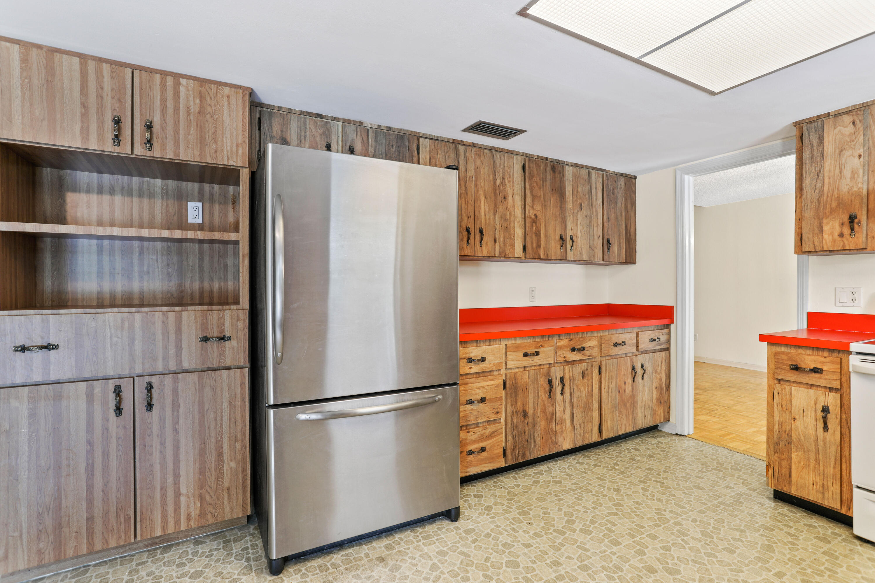 8791 Hidden Pines Road Fort Pierce, FL 34945 - Photo 18 of 55 a kitchen with refrigerator and cabinets