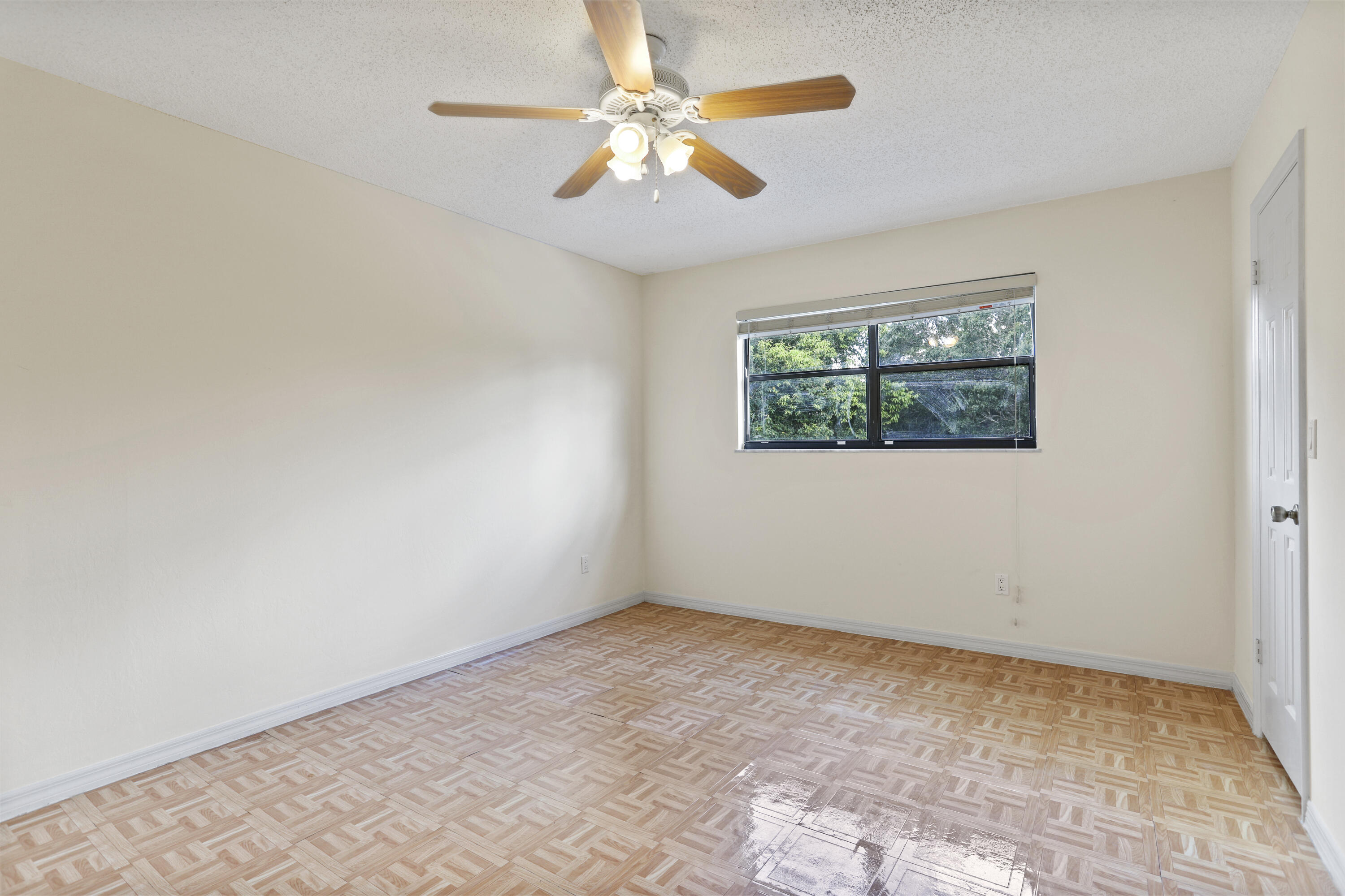 8791 Hidden Pines Road Fort Pierce, FL 34945 - Photo 30 of 55 an empty room with windows and fan