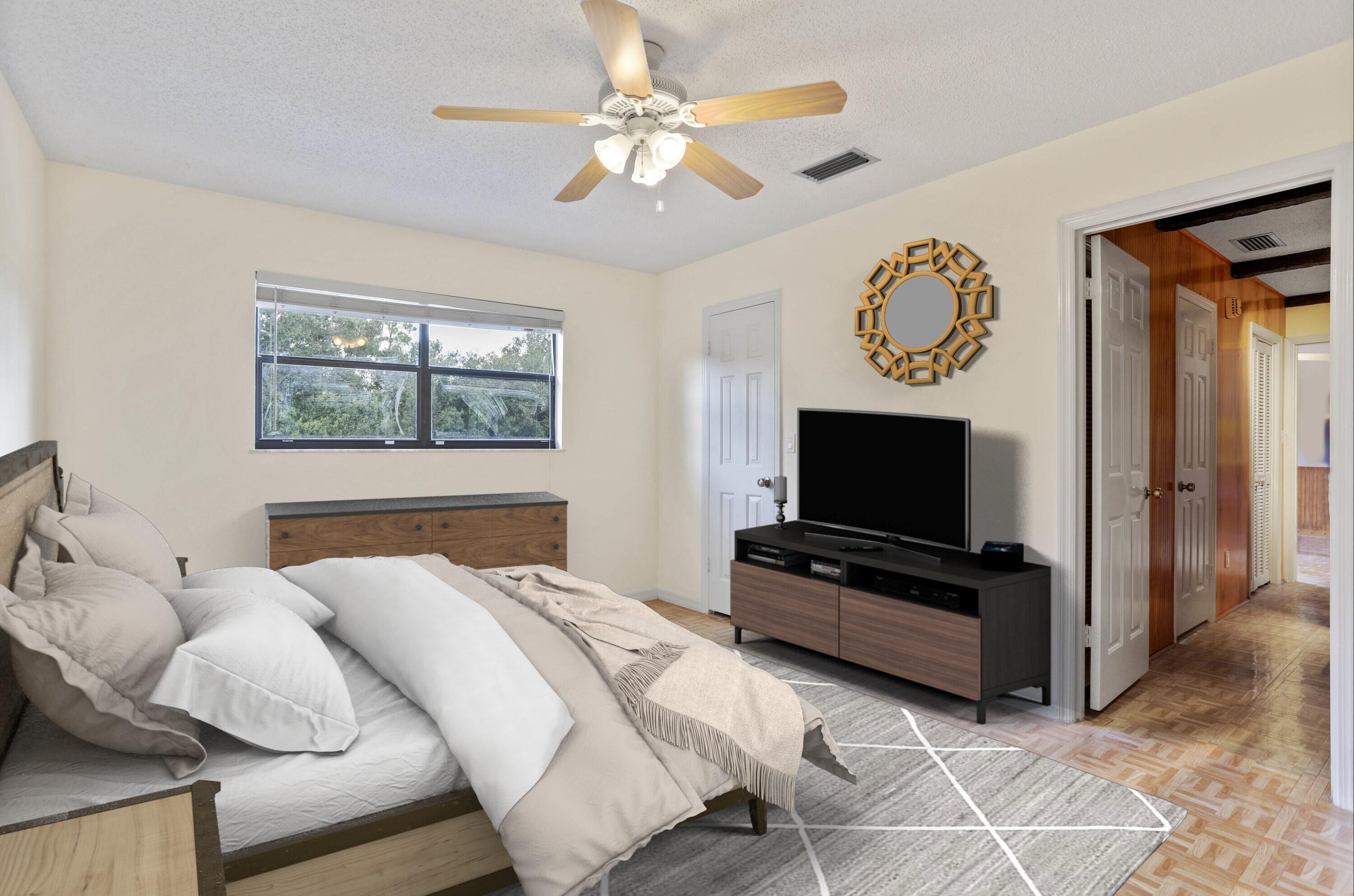 8791 Hidden Pines Road Fort Pierce, FL 34945 - Photo 31 of 55 a bedroom with furniture and a flat screen tv