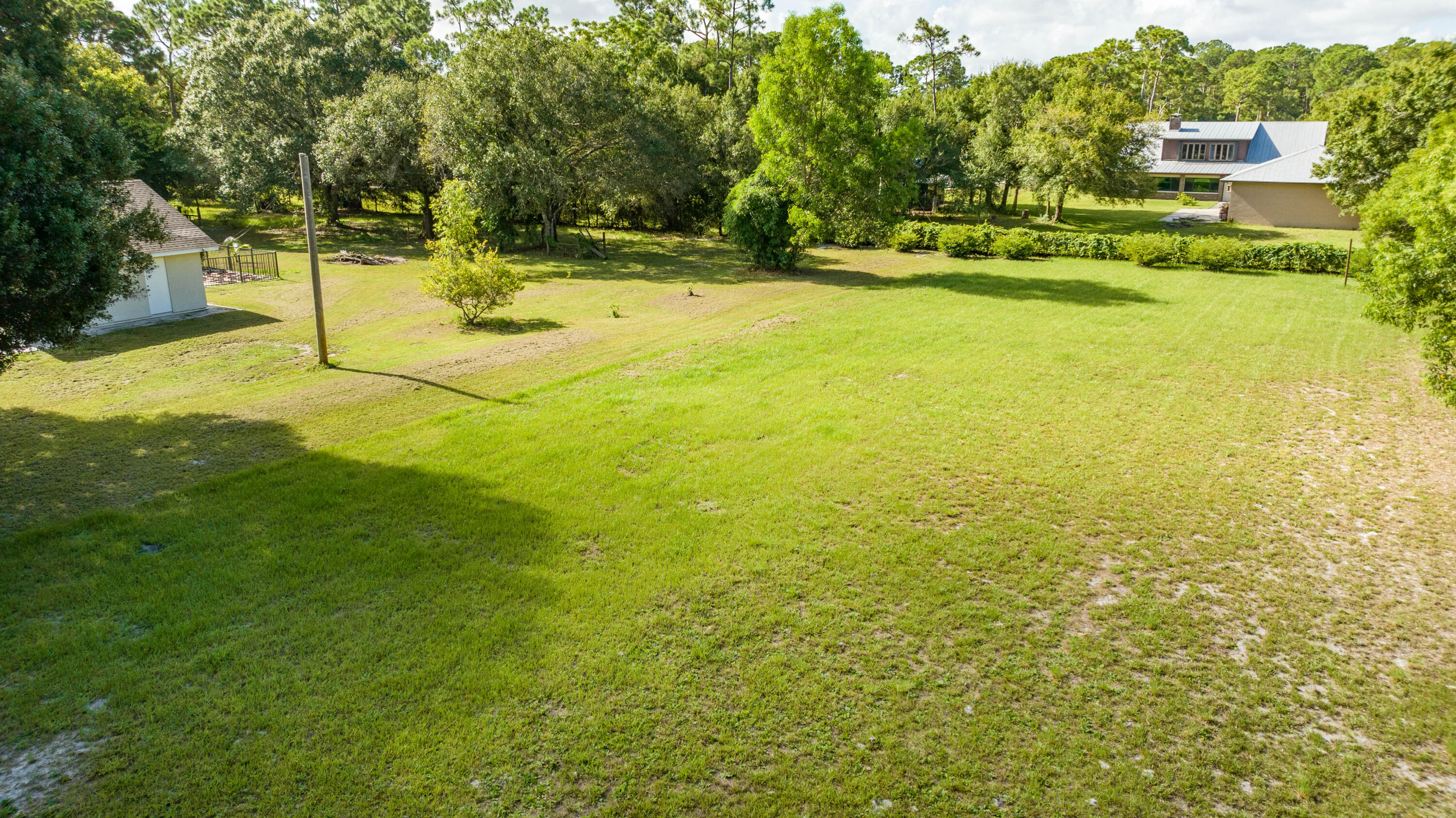 8791 Hidden Pines Road Fort Pierce, FL 34945 - Photo 47 of 55 a view of yard with swimming pool and trees
