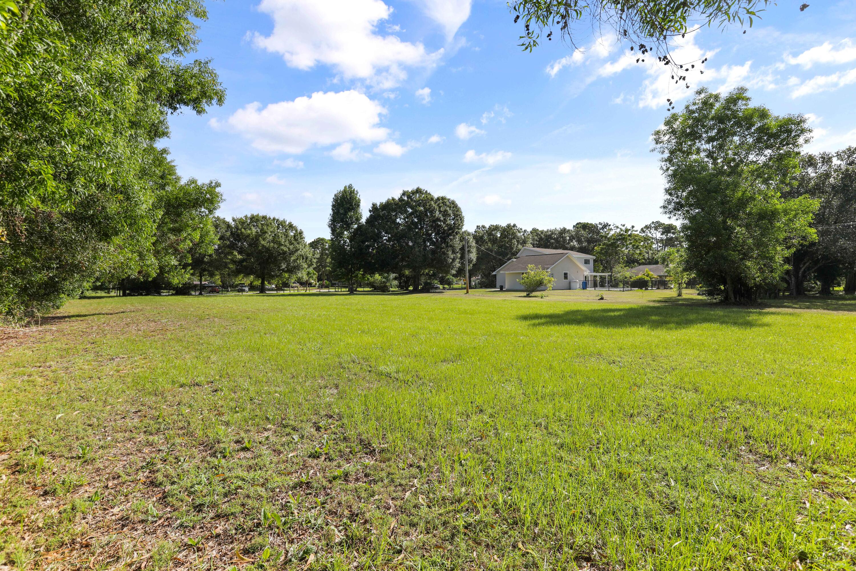 8791 Hidden Pines Road Fort Pierce, FL 34945 - Photo 54 of 55 a view of a green field with clear sky