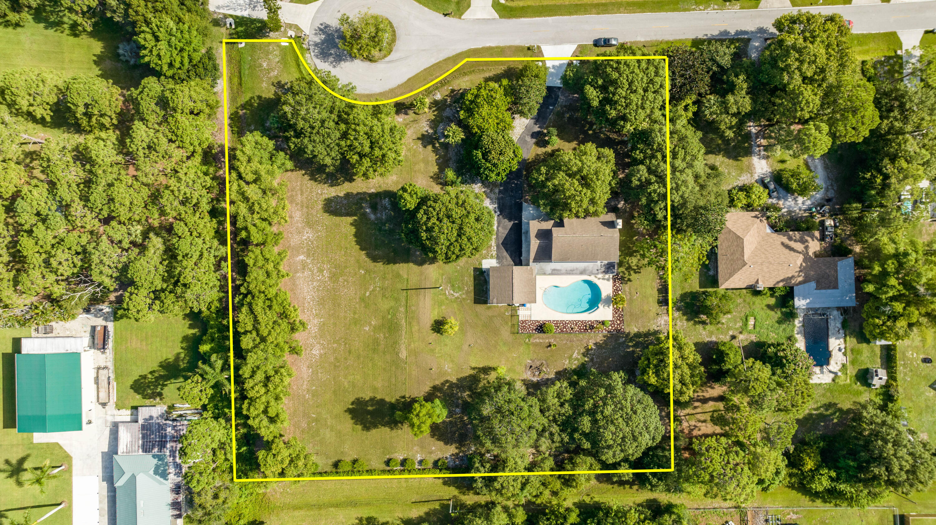 8791 Hidden Pines Road Fort Pierce, FL 34945 - Photo 6 of 55 an aerial view of residential house with outdoor space and trees all around