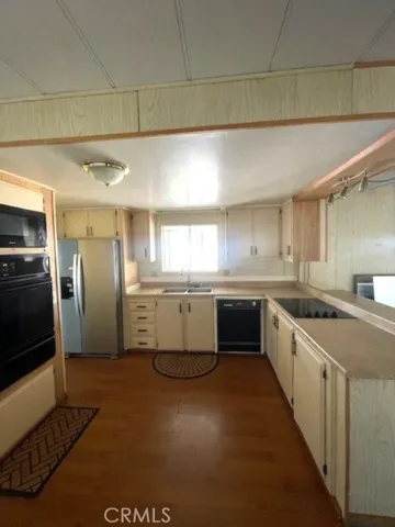 a large white kitchen with a sink and cabinets