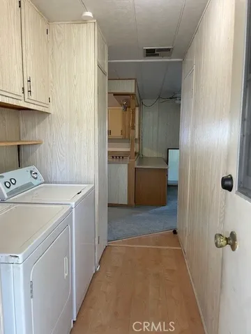 a view of a hallway with washer and dryer