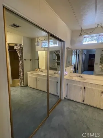 a bedroom with a bed and a lamp