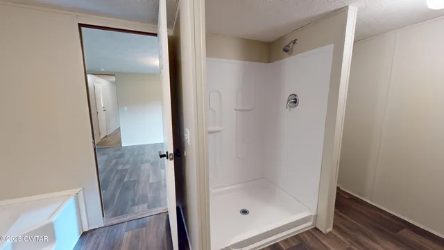 a bathroom with a glass shower door