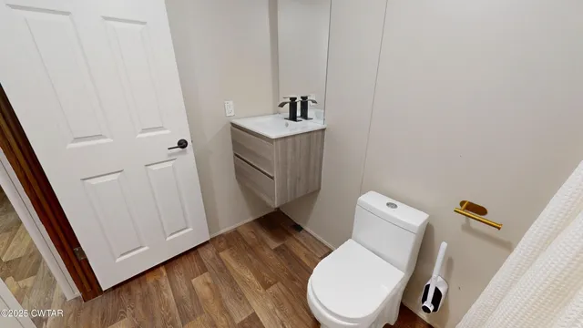 a white toilet sitting next to a bathroom sink