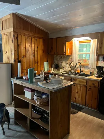 a kitchen with a sink stove and cabinets