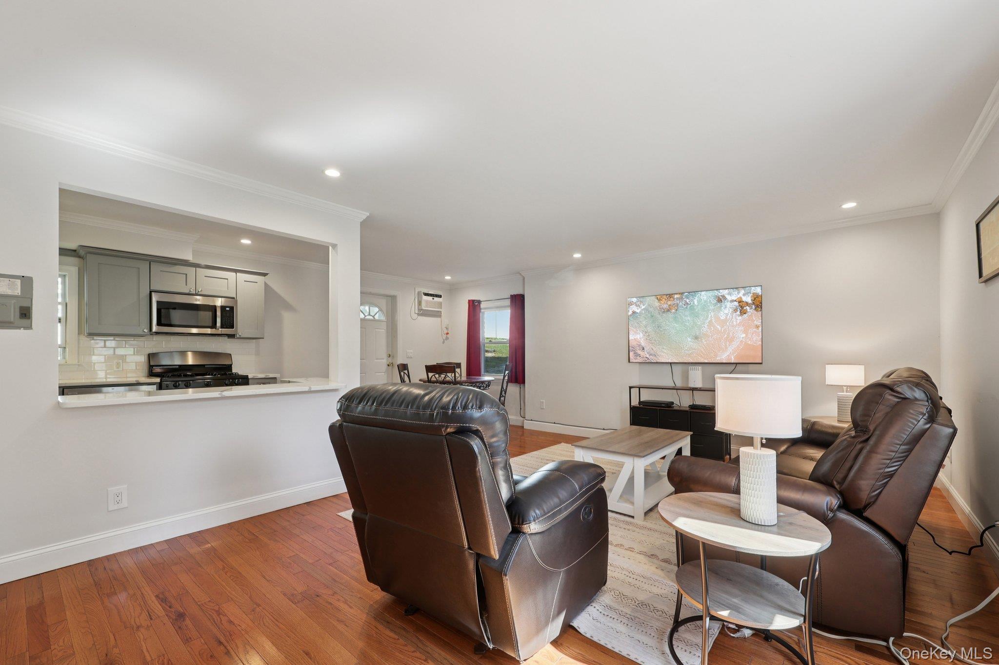 24 Wappanocca Avenue, Unit B Rye, NY 10580 - Photo 2 of 14 a living room with furniture a flat screen tv and kitchen view