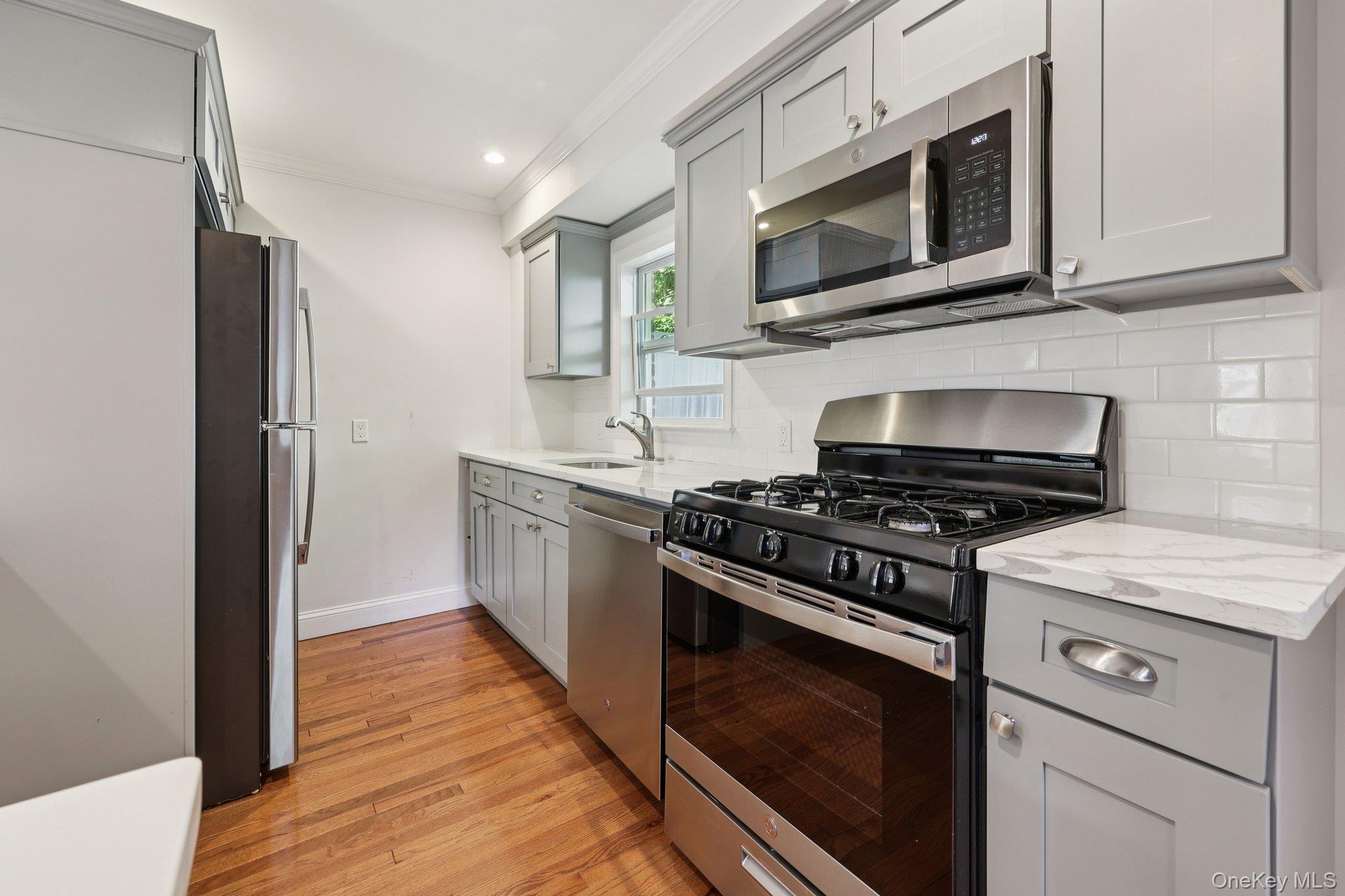 24 Wappanocca Avenue, Unit B Rye, NY 10580 - Photo 7 of 14 a kitchen with stainless steel appliances a stove microwave and refrigerator