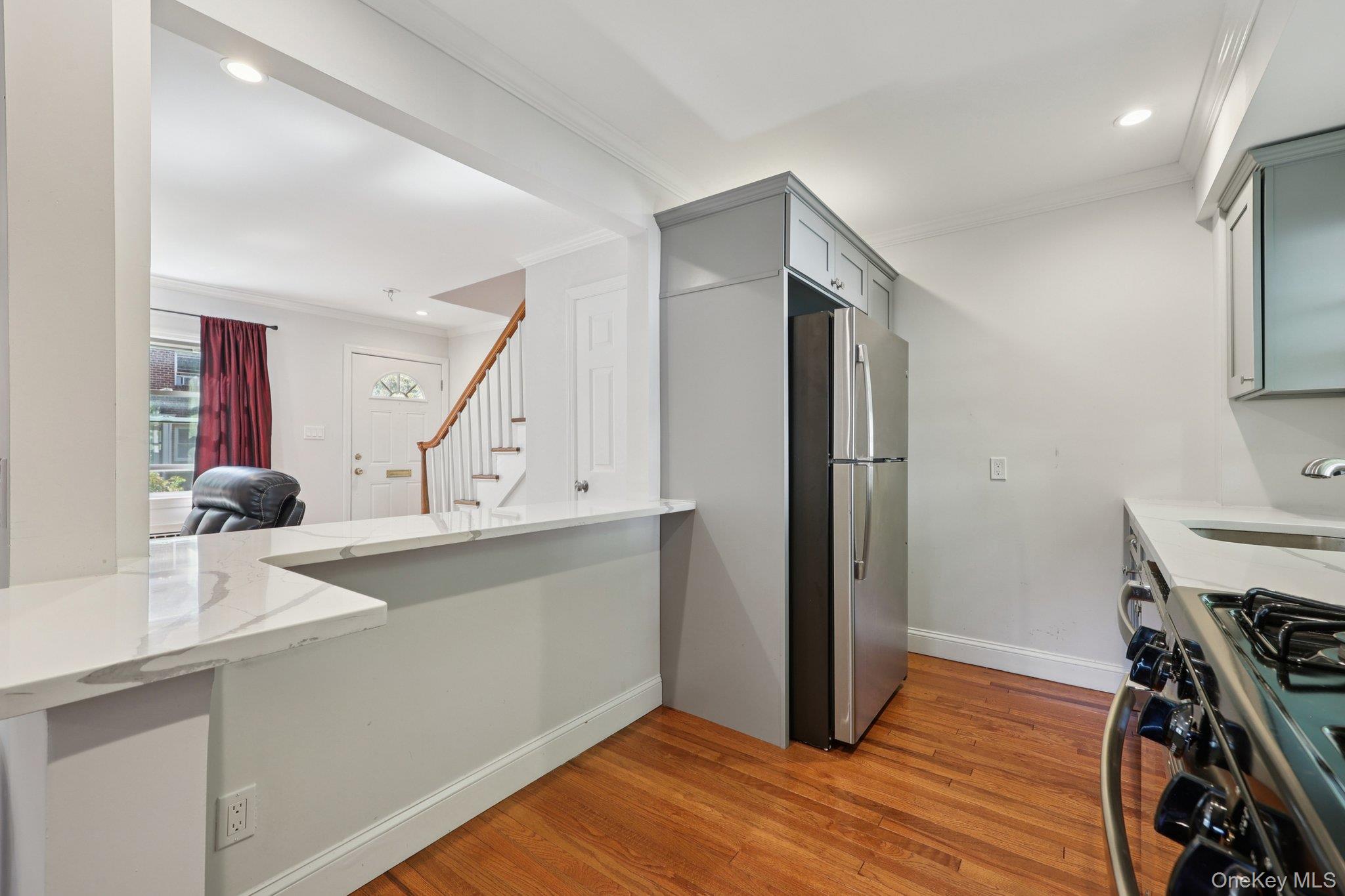 24 Wappanocca Avenue, Unit B Rye, NY 10580 - Photo 8 of 14 a kitchen with a sink a refrigerator and wooden floor