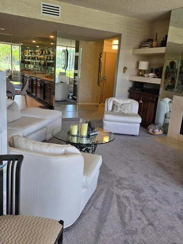 a room with furniture a rug and a window