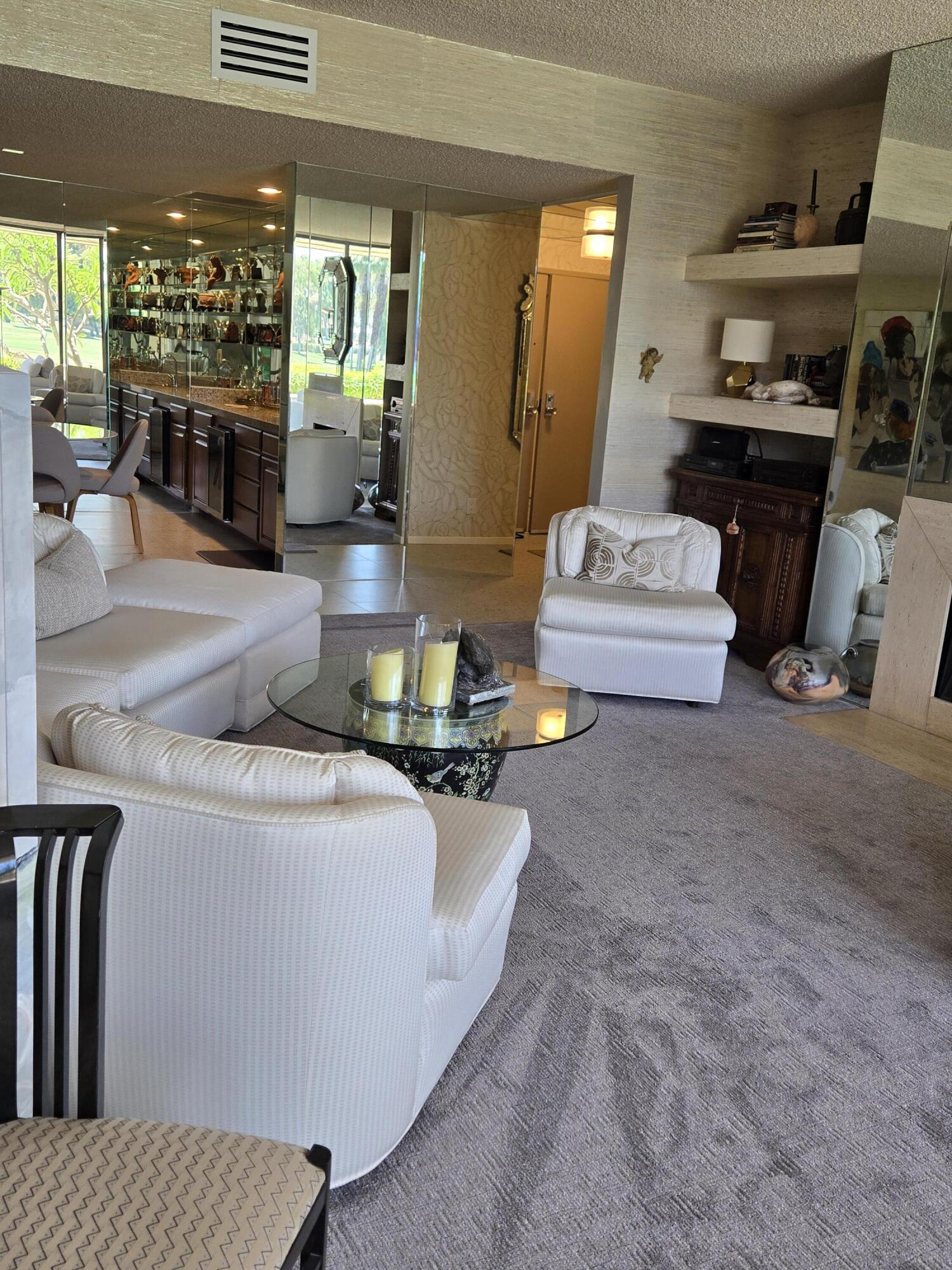 910 Island Drive, Unit 113 Rancho Mirage, CA 92270 - Photo 11 of 40 a living room with furniture and a fireplace