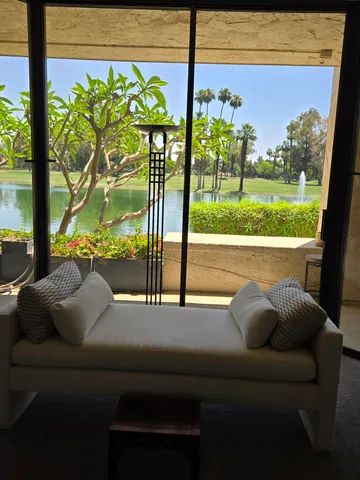 a bedroom with a bed and glass door