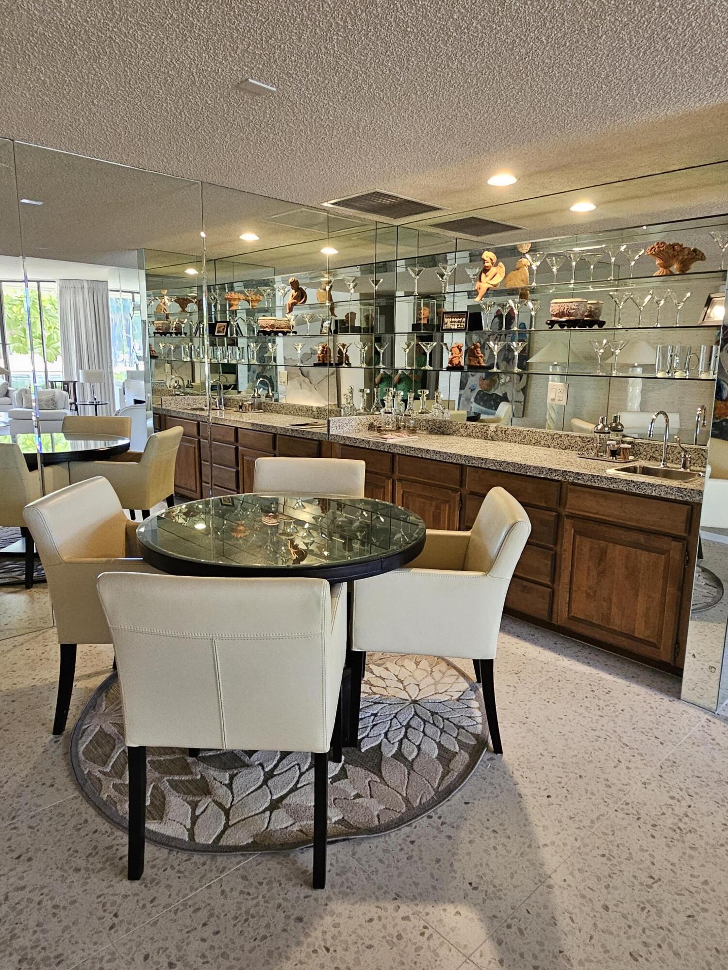 910 Island Drive, Unit 113 Rancho Mirage, CA 92270 - Photo 16 of 40 a dining room with a table and chairs