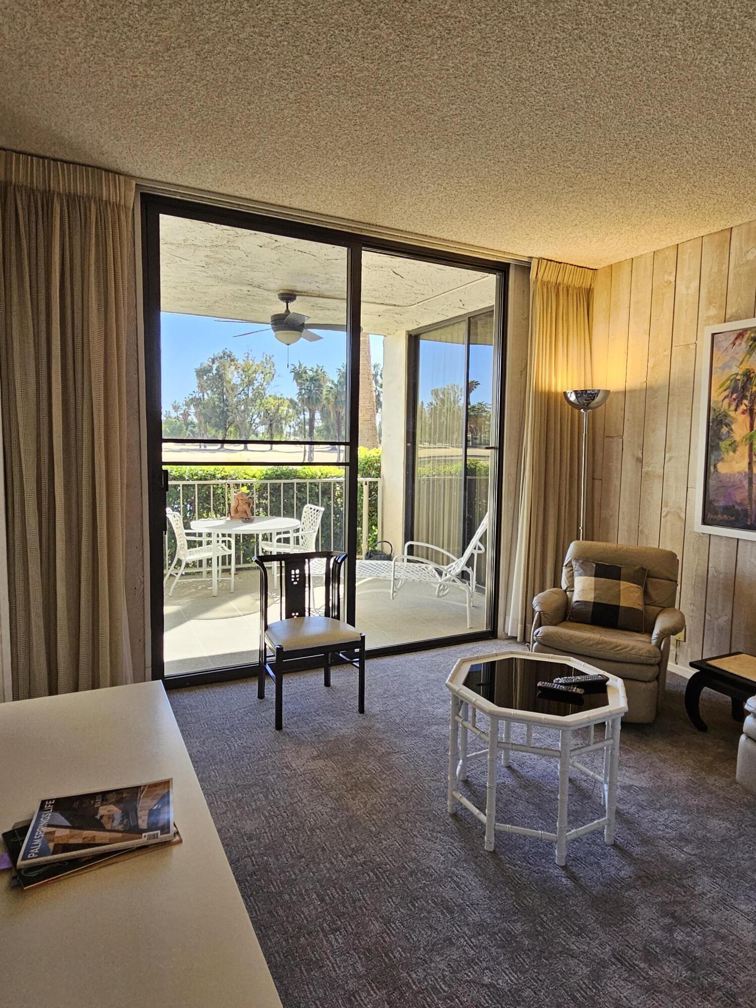 910 Island Drive, Unit 113 Rancho Mirage, CA 92270 - Photo 20 of 40 a living room with furniture and a large window