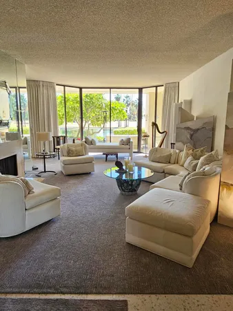 a living room with furniture and a floor to ceiling window