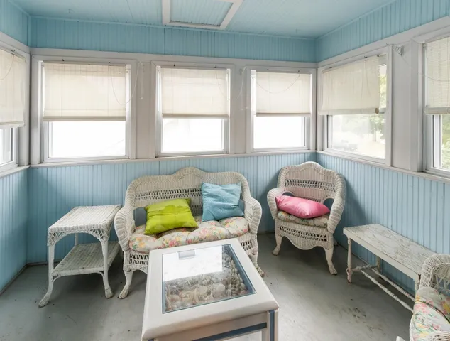 a bathroom with a sink a toilet a window and shower