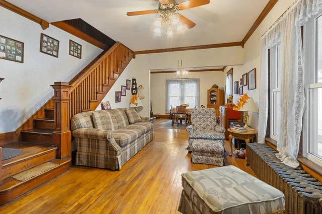 a living room with furniture and wooden floor