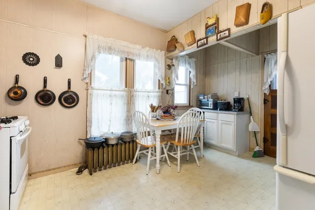 a dining room with furniture and a clock