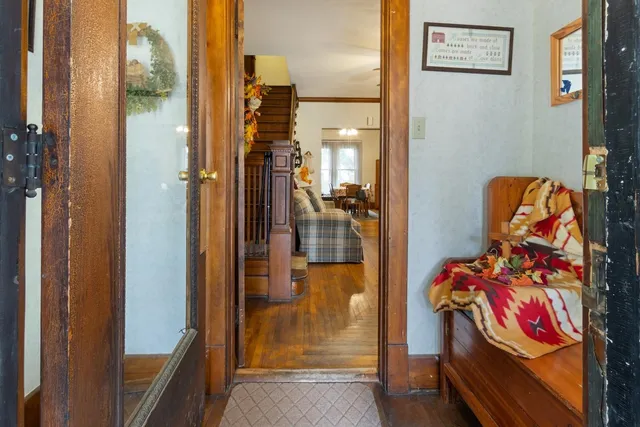 a view of a hallway with wooden floor