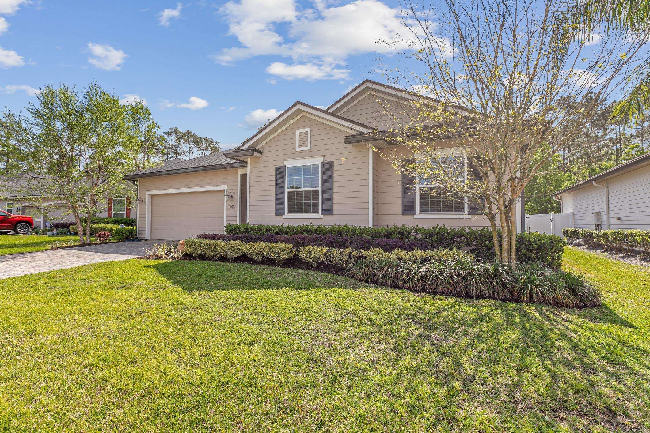a front view of a house with garden