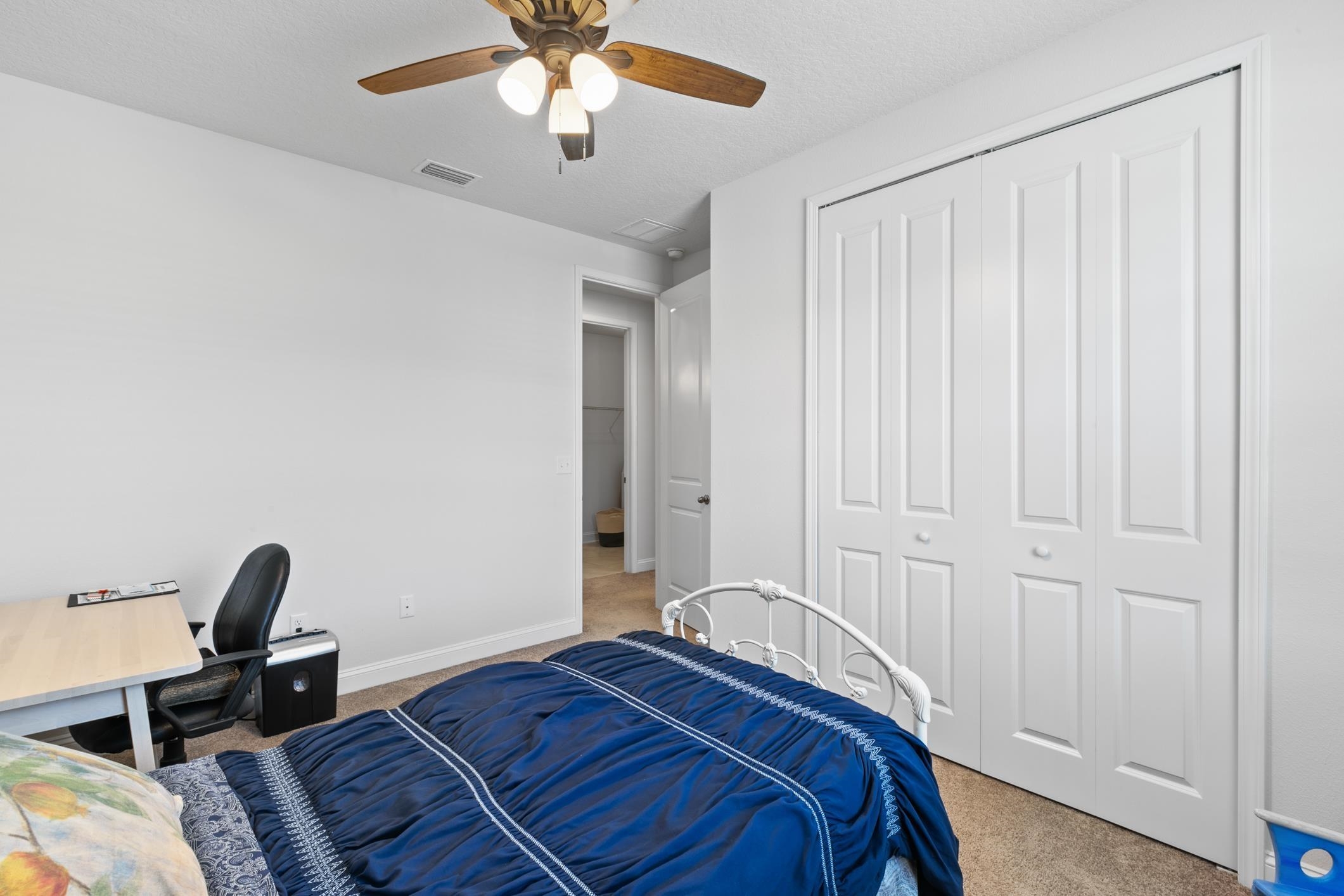 345 Downs Corner Road St. Augustine, FL 32092 - Photo 29 of 38 a bedroom with a bed and a chandelier
