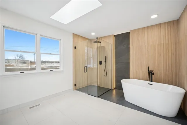a bathroom with a bathtub and a shower