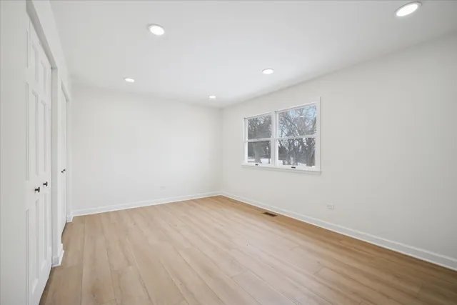 wooden floor in a hall with a window