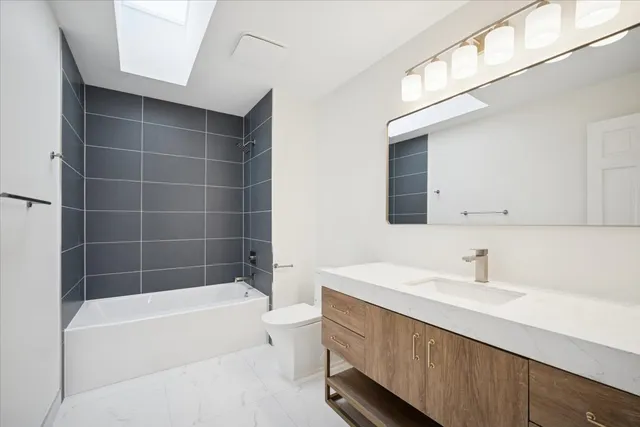 a bathroom with a bathtub a sink and a mirror