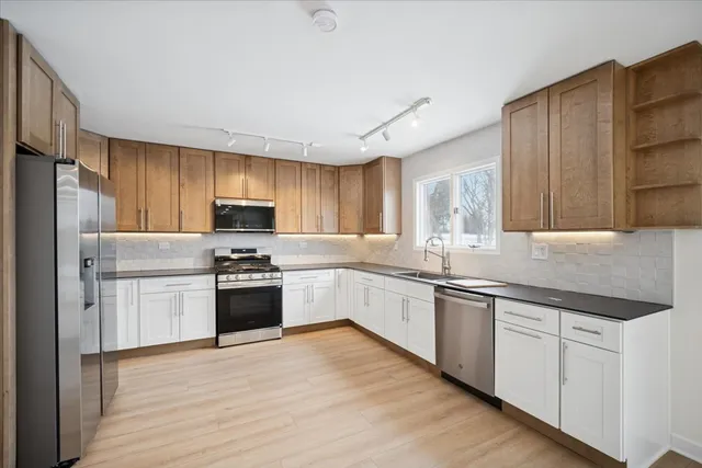 a kitchen with granite countertop stainless steel appliances and wooden cabinets