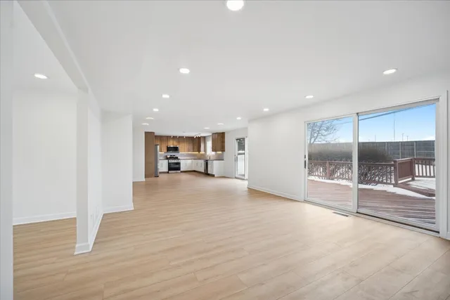 a view of kitchen with refrigerator and window