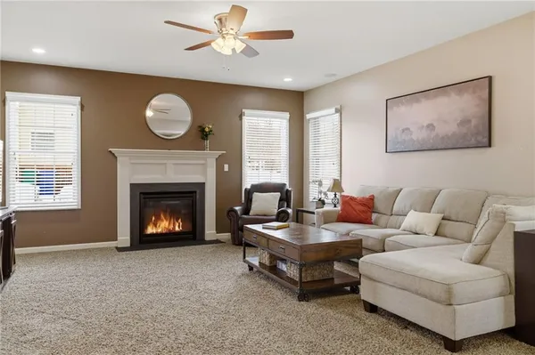 a living room with furniture chandelier and a fireplace