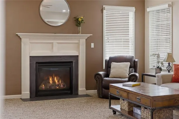 a living room with furniture a table and a fireplace