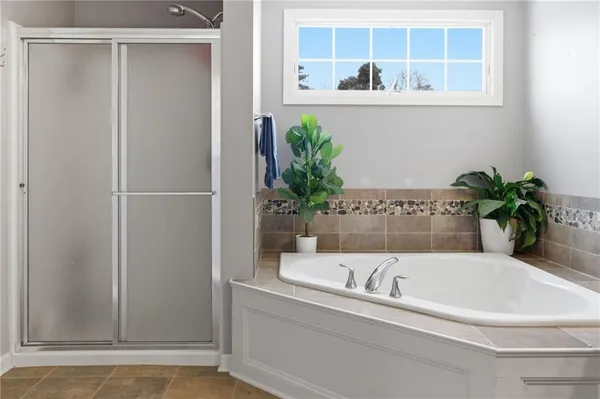 a white bath tub with shower