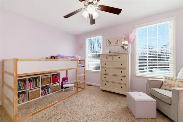 a bedroom with a bed and a book shelf