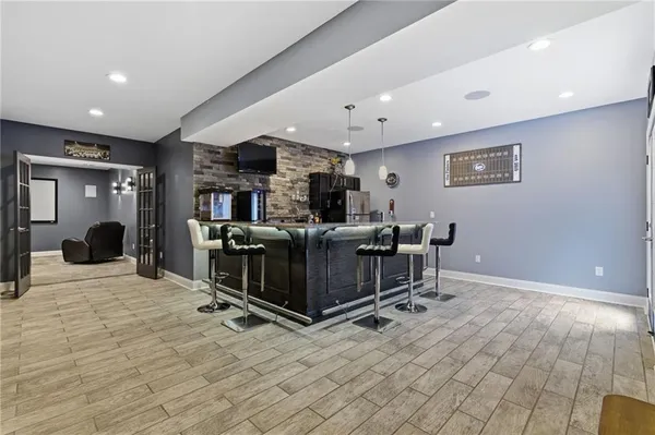 a living room with furniture a flat screen tv and a table