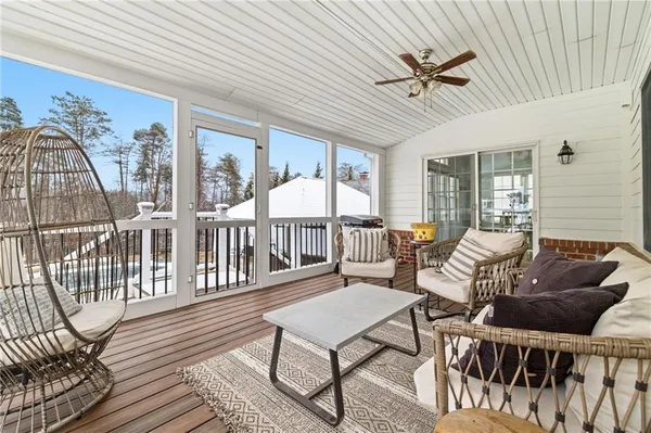 a living room with furniture a fireplace and a floor to ceiling window