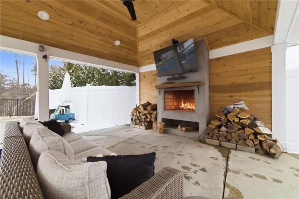 a living room with furniture a fireplace and a table