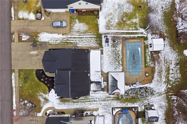 an aerial view of multiple houses with yard