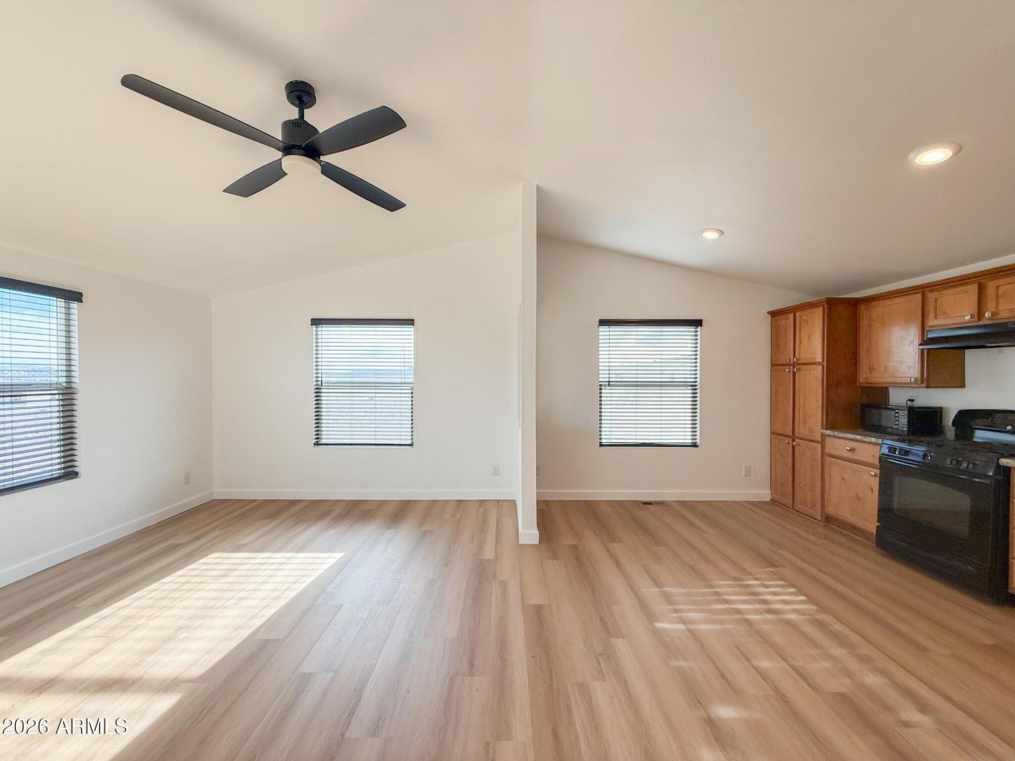 51880 North Gold Plains Road Seligman, AZ 86337 - Photo 8 of 24 a view of empty room with wooden floor and window