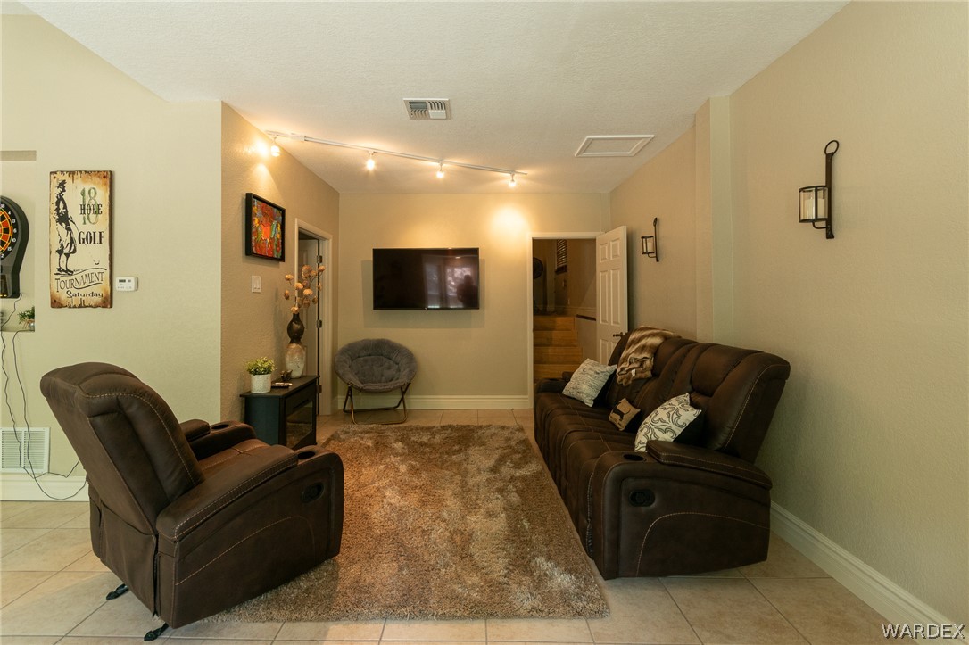 6615 Flag Mine Road Kingman, AZ 86401 - Photo 37 of 72 a living room with furniture and a flat screen tv