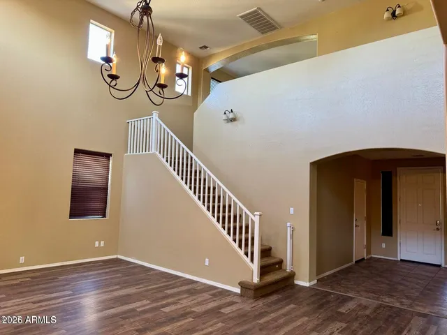 a view of a livingroom with stairs and furniture