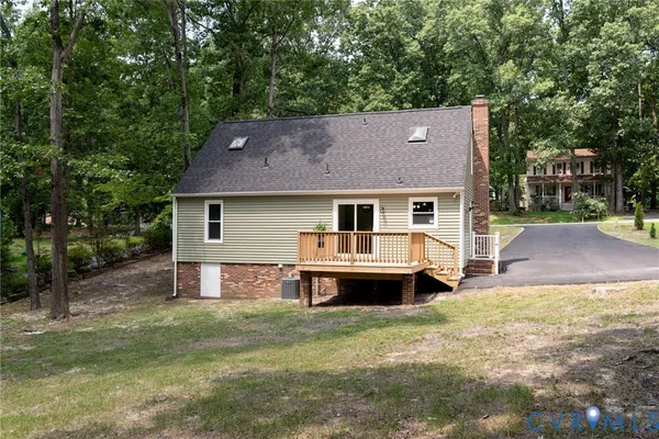a front view of a house with a garden and deck