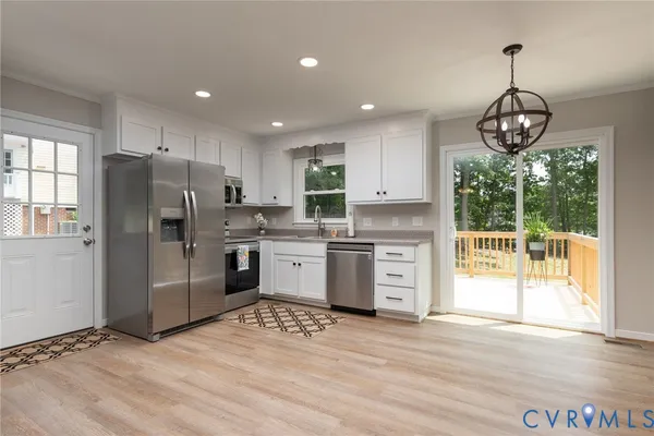 a kitchen with stainless steel appliances granite countertop a refrigerator and a stove top oven