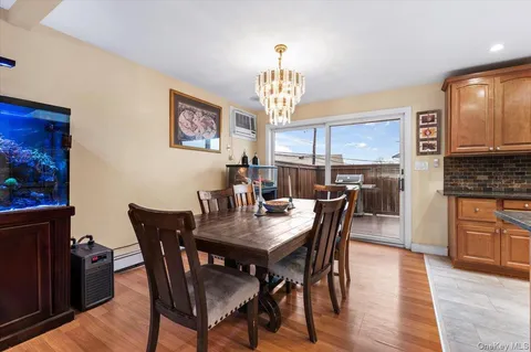 a view of a dining room with furniture a chandelier and wooden floor